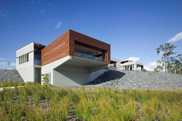 A large modern concrete commercial building with a timber and concrete facade.